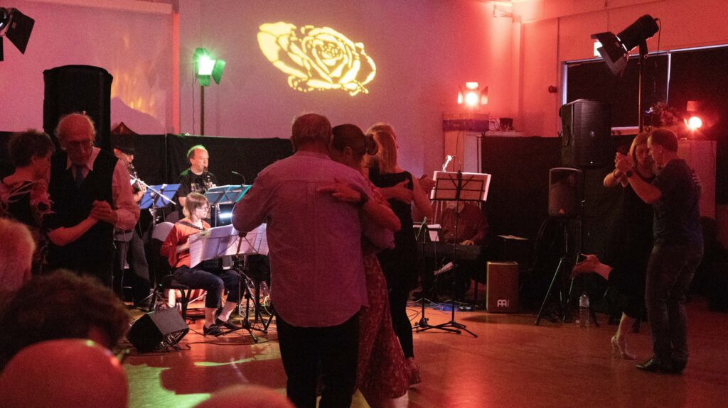 Orchestra playing plus dancers red